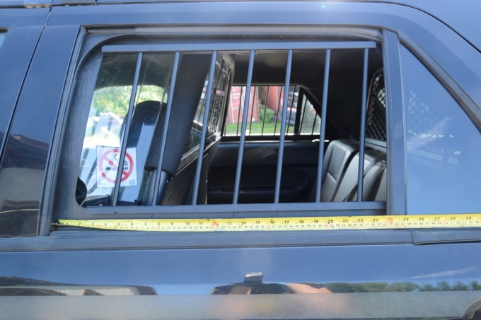 Figure 2 - A close-up of the bars on the back window with a measuring tape showing their spacing.