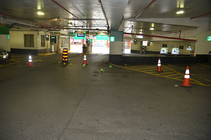 This is an image of a parking garage with markers placed on the floor depicting evidence locations for case 17-OFD-135.