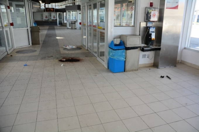 One of the Complainant’s knives is seen on the floor to the right of the photo; the blood pooling indicates the location where the Complainant fell after being shot.  (The entrance doors are to the right in the photo and the security office to the left.)  