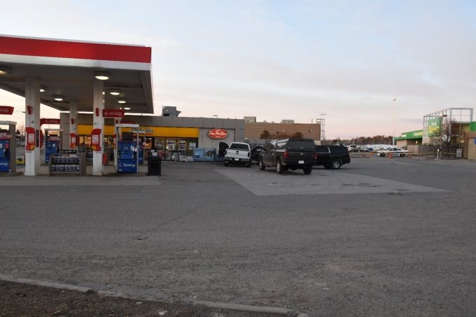 Figure 1 – The gas station on Regent Street in Sudbury after the shooting. The Complainant's white Ford F-150 can be seen partially surrounded by police vehicles.
