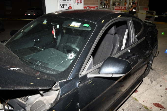 Figure 2 - Bullet strikes to the Ford Mustang's hood, front windshield and driver's door.