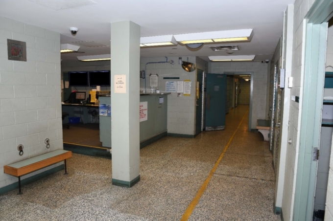 Figure 1 - The booking area at the police station.  The open green door leads to a search room. 