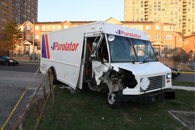 Figure 1 – A Purolator cube van with apparent damage to the right-side door area stopped on the west side of Brimley Road
