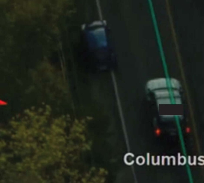 Figure 6 - Screenshot of aerial footage showing the blue Nissan veering towards the side of the road after it contacted the SO's police vehicle.
