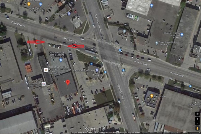 Figure 1 - Screenshot from Google Maps with a red thumbtack on 301 Rexdale Boulevard and red arrows marking the driveway entrances to the property 