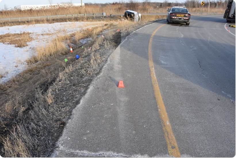 Image 1 - Road markings indicating the location where the Land Rover left the off-ramp into the ditch between the eastbound off-ramp and the eastbound on-ramp on the south side of Highway 401.  